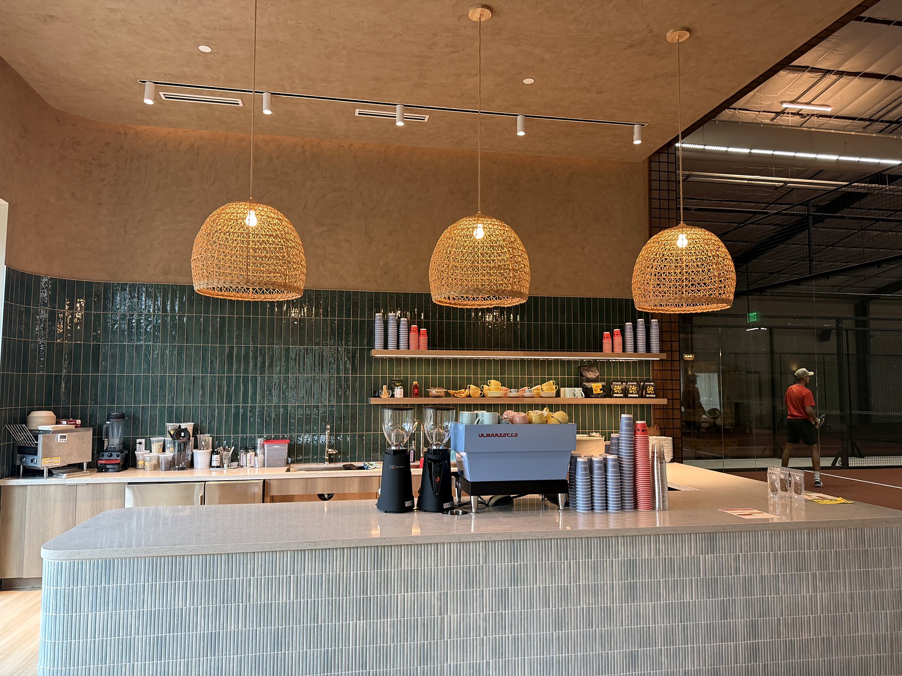 The Revolución café bar with rattan lamps and green tile