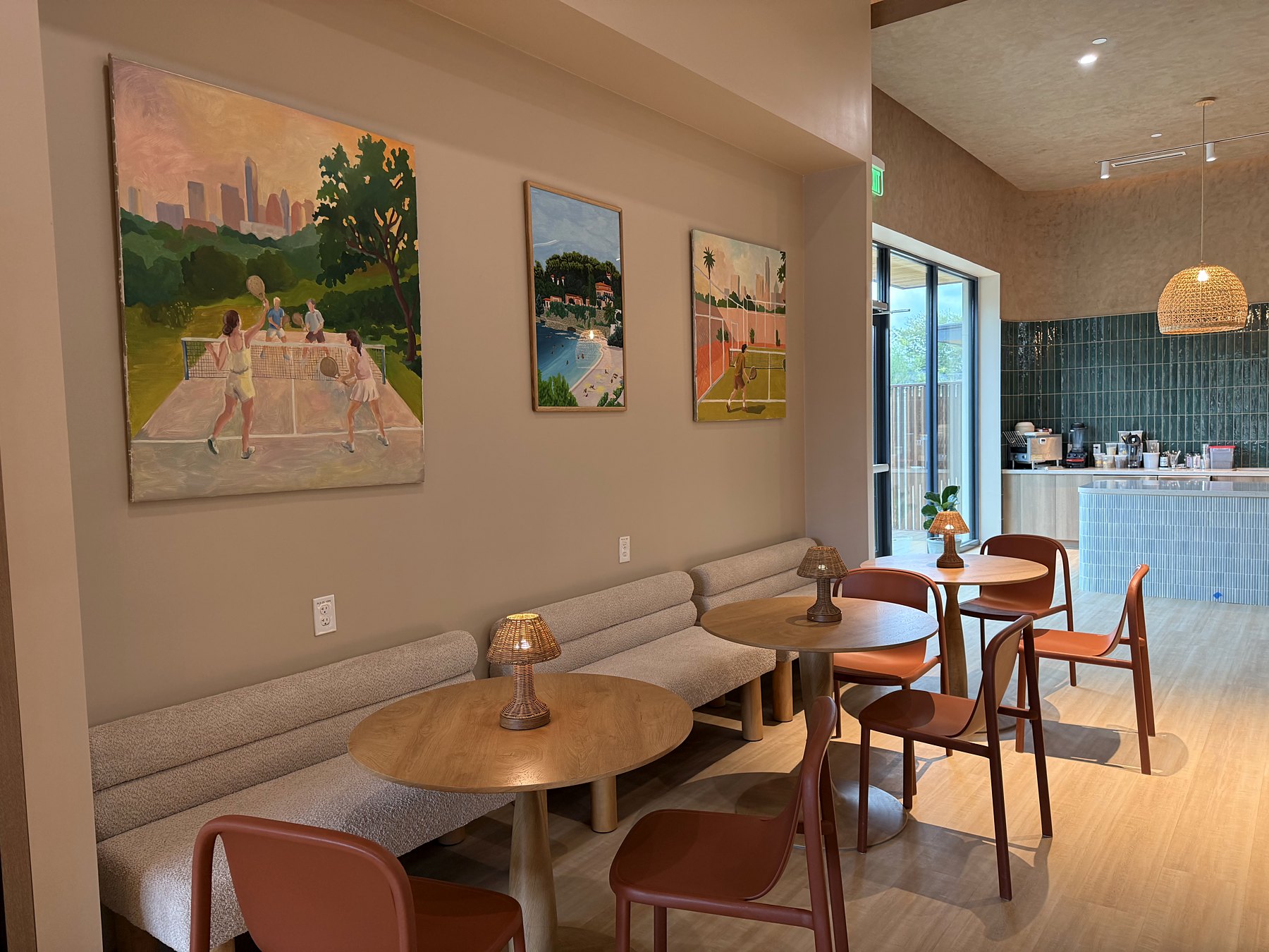 Café seating with padel paintings on the wall
