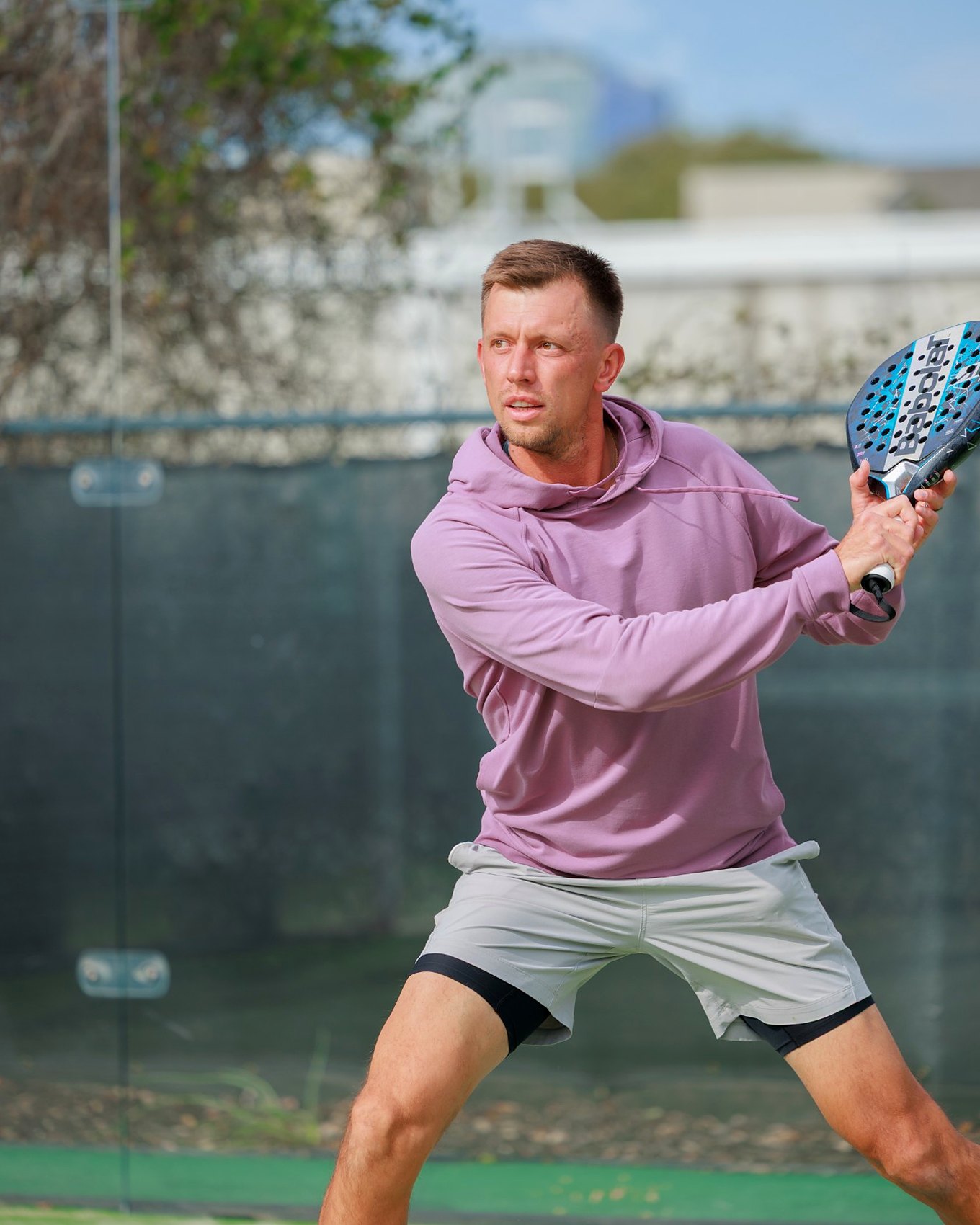 Archie, Director of Padel at the Padel Collective Austin, hitting a backhand